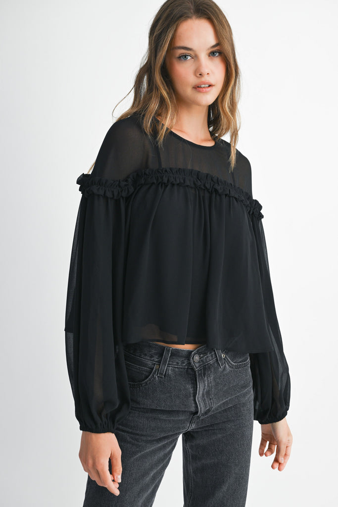Woman's black blouse with sheer sleeves and ruffle